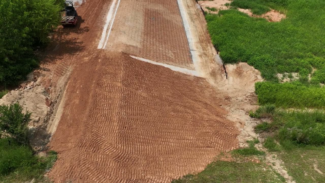 Aerial view of a graded access road on a land site