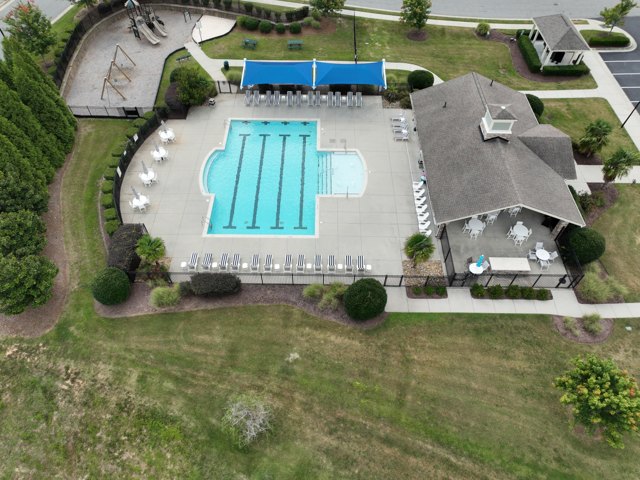 Amenity center and pool deck &mdash; roof, shade, deck and fencing in one frame